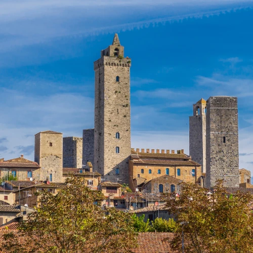 The medieval towers of San Gimignano, nestled in the hilly Tuscan landscape, a symbol of the region's rich artistic and cultural heritage.